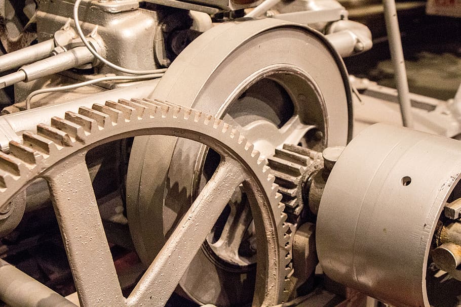 Two cogwheels within a monumental machinery. The whole image is in sepia tones